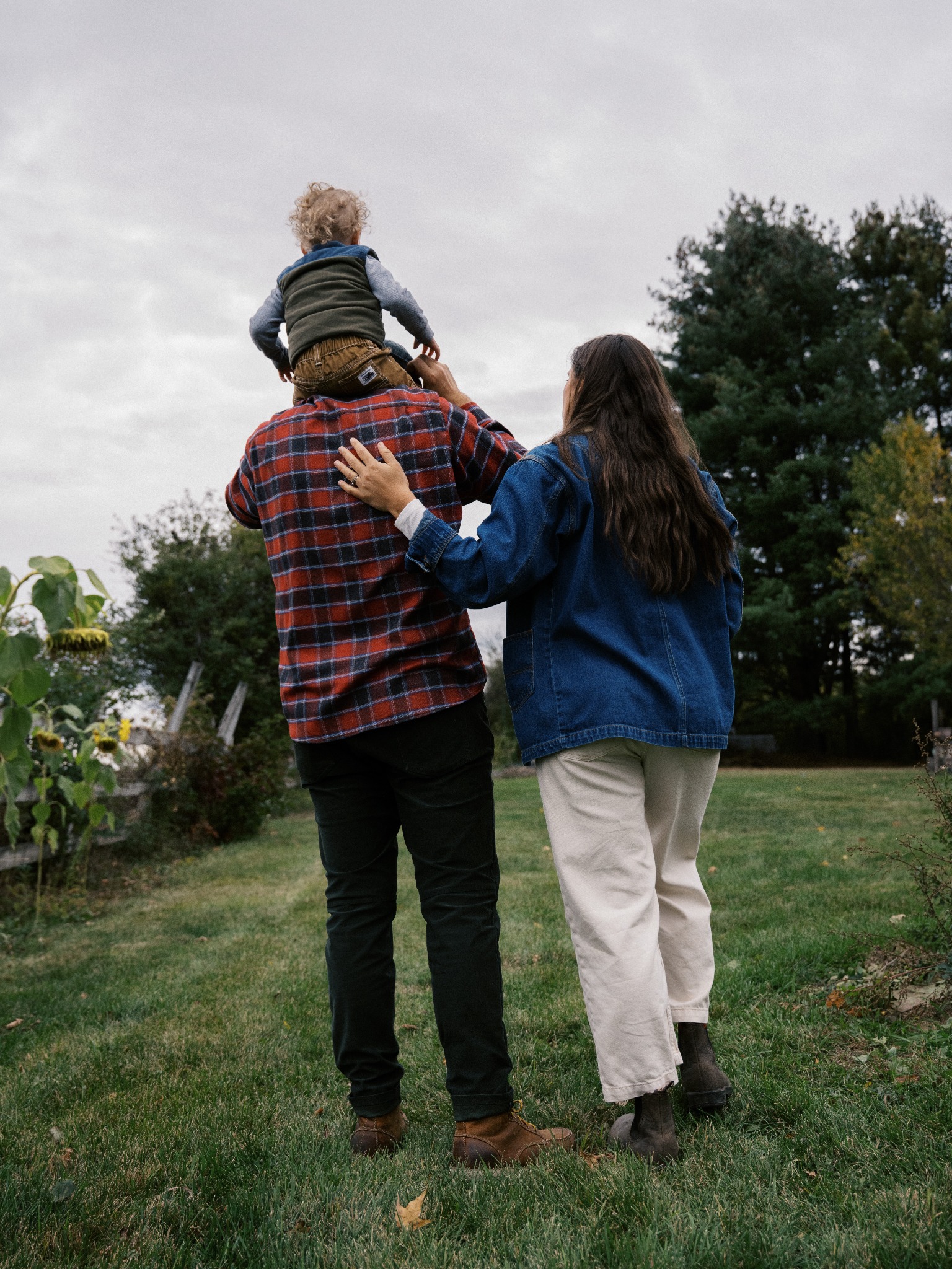 Parents walking with their child on a shoulder