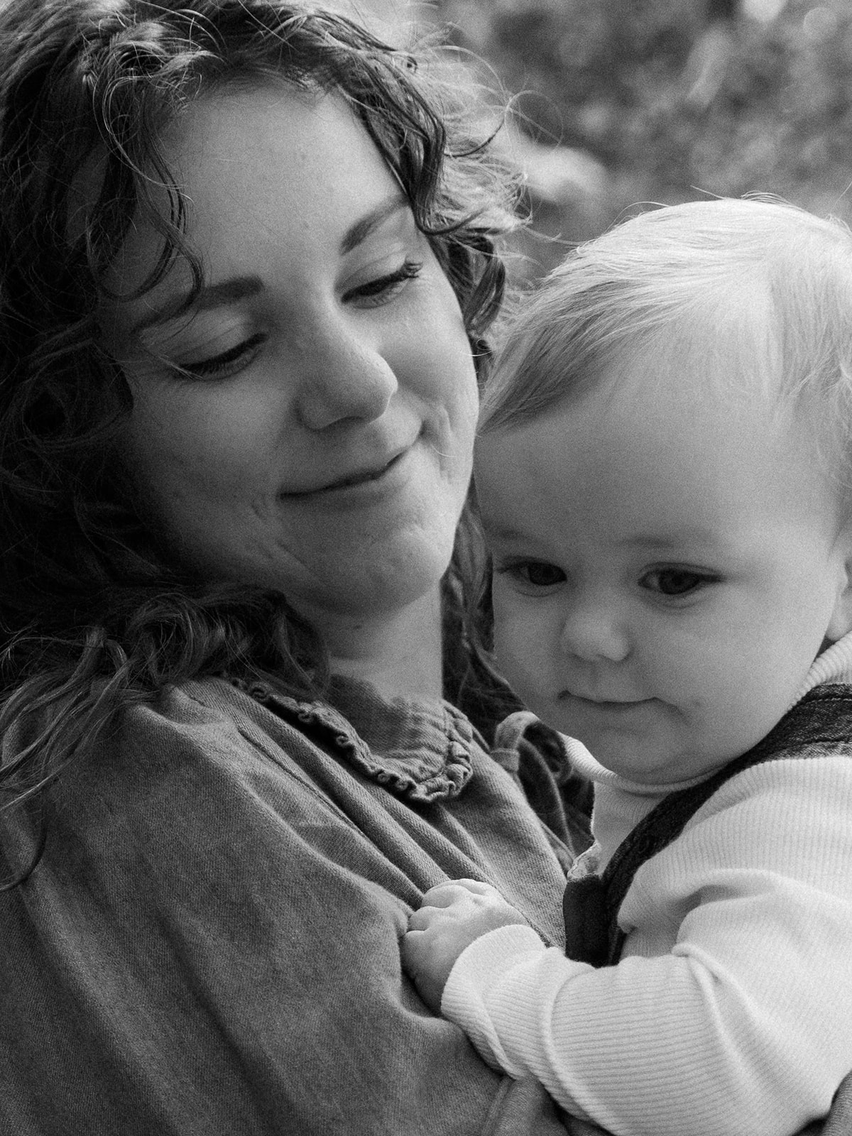 A mother holding her baby close